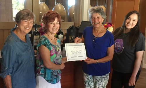 Oakland, Calif., resident Melania Ciapponi, third from the left, picked up her prize from the 2016 Lake County Wine Adventure raffle on Wednesday, August 31, 2016. Raffle proceeds went to the American Cancer Society. Pictured from left are Madi Mount, owner, Boatique Winery; Terry Dereniuk, Lake County Winery Association director; Melania Ciapponi; and Karissa Gutierrez, American Cancer Society. Courtesy photo. 083116wineweekendraffle