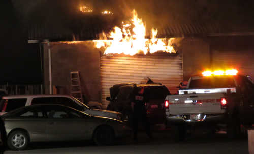 Fire emerges from inside an repair shop in Kelseyville, Calif., late on Monday, September 19, 2016. Photo by Rob Grant. 091916mikesautorobgrant1