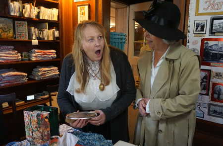 At left, Linda Bushta, the librarian at the Harriet Lee Hammond Library in Upper Lake, Calif., reacts with surprise to a gift from Hammond's family of a silver brush given Harriet Hammond by her husband on their 25th anniversary in 1913 as fellow Lake County Library staffer Jan Cook looks on. Bushta also received books that had been part of Hammond's private collection during the library's centennial celebration on Sunday, October 16, 2016. Photo by Elizabeth Larson/Lake County News. 101616hammondlibrarybushta