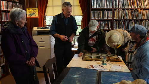 From left, Kit Everts and her son John Everts look on as community members look at a picture book of Harriet Hammond's time in Lake County, Calif., during the centennial celebration for the Harriet Lee Hammond Library in Upper Lake, Calif., on Sunday, October 16, 2016. Photo by Elizabeth Larson/Lake County News. 101616hammondlibrarypicbook
