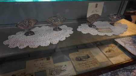 Shown at the top of a display at the Hammond Library in Upper Lake, Calif., on Sunday, October 16, 2016, are silver card holders given to Harriet Lee Hammond by her brother-in-law, President Theodore Roosevelt. The card holders were loaned to the library for the centennial celebration. Photo by Elizabeth Larson/Lake County News. 101616harriethammondcardholders