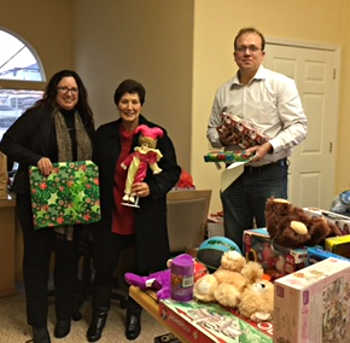 On Thursday, December 15, 2016, members of the Konocti Lioness Club delivered gifts for community members served by the Lake Family Resource Center to the organization's headquarters in Kelseyville, Calif. From left to right, Lake Family Resource Center Executive Director Jennifer Dodd, Konocti Lioness member Lonny Rittler, and Michael Stajura, center project director. Courtesy photo. 121516lfrctoys