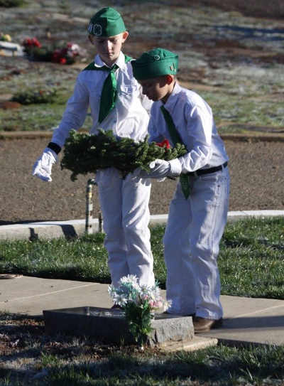 Two young 4-H members lay a wreath on the grave of a veteran during the Wreaths Across America ceremony at Hartley Cemetery in Lakeport, Calif., on Saturday, December 17, 2016. Photo courtesy of Ginny Craven. 121716wreaths4hers