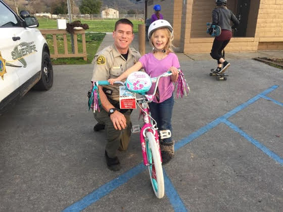 Lake County Sheriff's deputies got to help distribute toys purchased by celebrity chef and restaurateur Guy Fieri in December 2016 to children in Lake County, Calif. Photo courtesy of Sheriff Brian Martin. 122116fieritoydrivebike