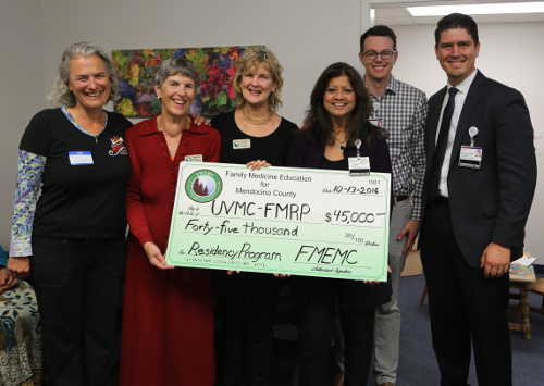 Funds raised by the Rural Health Rocks event in April 2016 are presented to Ukiah Valley Medical Center in Ukiah, Calif., for its local Family Medicine Residency Program. From left to right, Noemi Doohan, MD, PhD; Daphne Macneil, president, FMEMC; Mary Anne Landis, vice president, Family Medicine Education for Mendocino County; Gwen Matthews, president and chief executive officer, UVMC; Aaron Poole, chief financial officer, UVMC; and David Weis, chief operating officer, UVMC. Courtesy photo. oct2016uvmcdonations