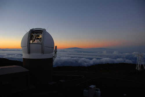 This compressed view of the entire sky visible from Hawai'i by the Pan-STARRS1 Observatory is the result of half a million exposures, each about 45 seconds in length, taken over a period of four years. The shape comes from making a map of the celestial sphere, like a map of the Earth, but leaving out the southern quarter. The disk of the Milky Way looks like a yellow arc, and the dust lanes show up as reddish brown filaments. The background is made up of billions of faint stars and galaxies. If printed at full resolution, the image would be 1.5 miles long, and you would have to get close and squint to see the detail. Credit: Danny Farrow, Pan-STARRS1 Science Consortium and Max Planck Institute for Extraterrestial Physics. panstarrsuniversecatalog