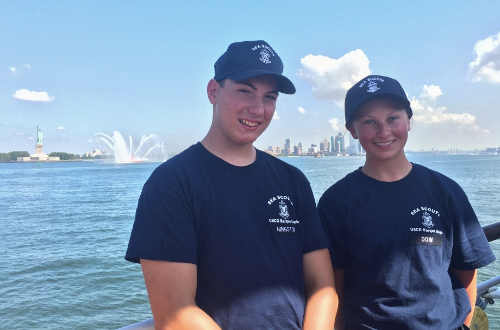 Justin Hingston of Middletown, Calif., and Kaitlyn Dow of New London, Conn., were two of six Sea Scouts selected nationally to join US Coast Guard first year cadets on their first summer training cruise aboard the USCG Tall Ship Eagle. The ship sailed from Salem, Mass., to New York City, seen in the background. Photo courtesy of the US Coast Guard. seascoutshingstonanddow